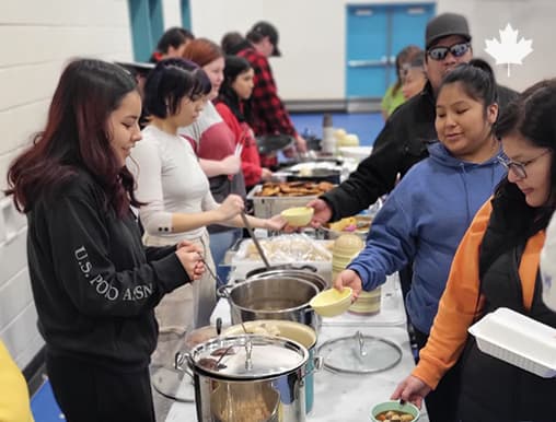 Volunteers behind a community kitchen